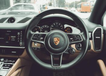 the interior of a car with a steering wheel and dashboard